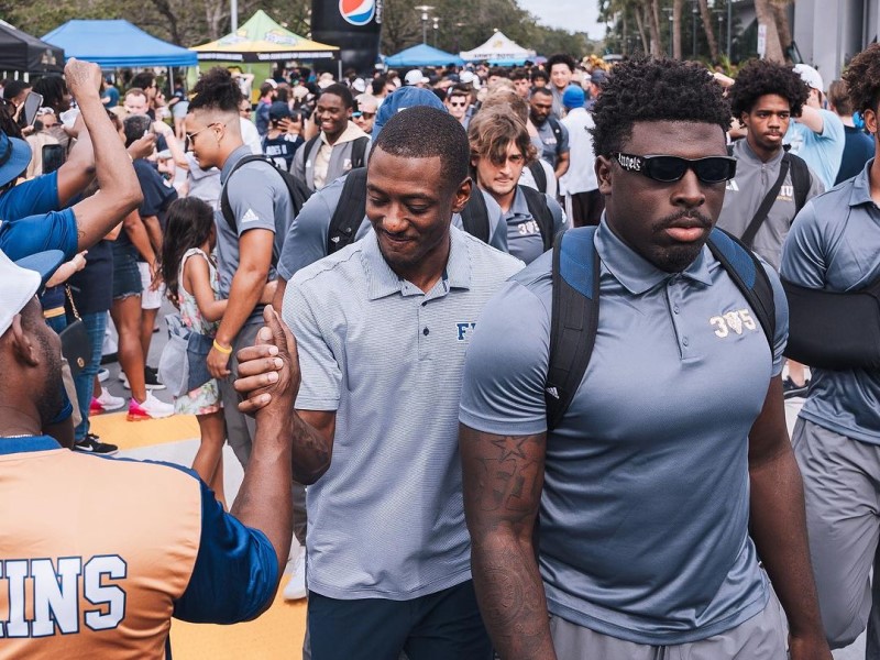 Football player greeting an alum